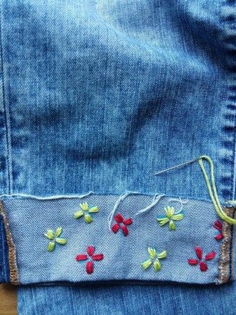 embroidered-denim-diy Finish adding flowers all around the hem