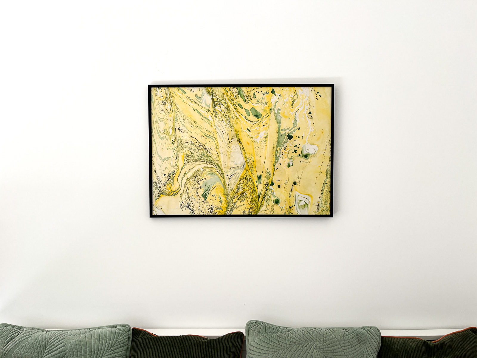 Marbled art in yellow and green on paper