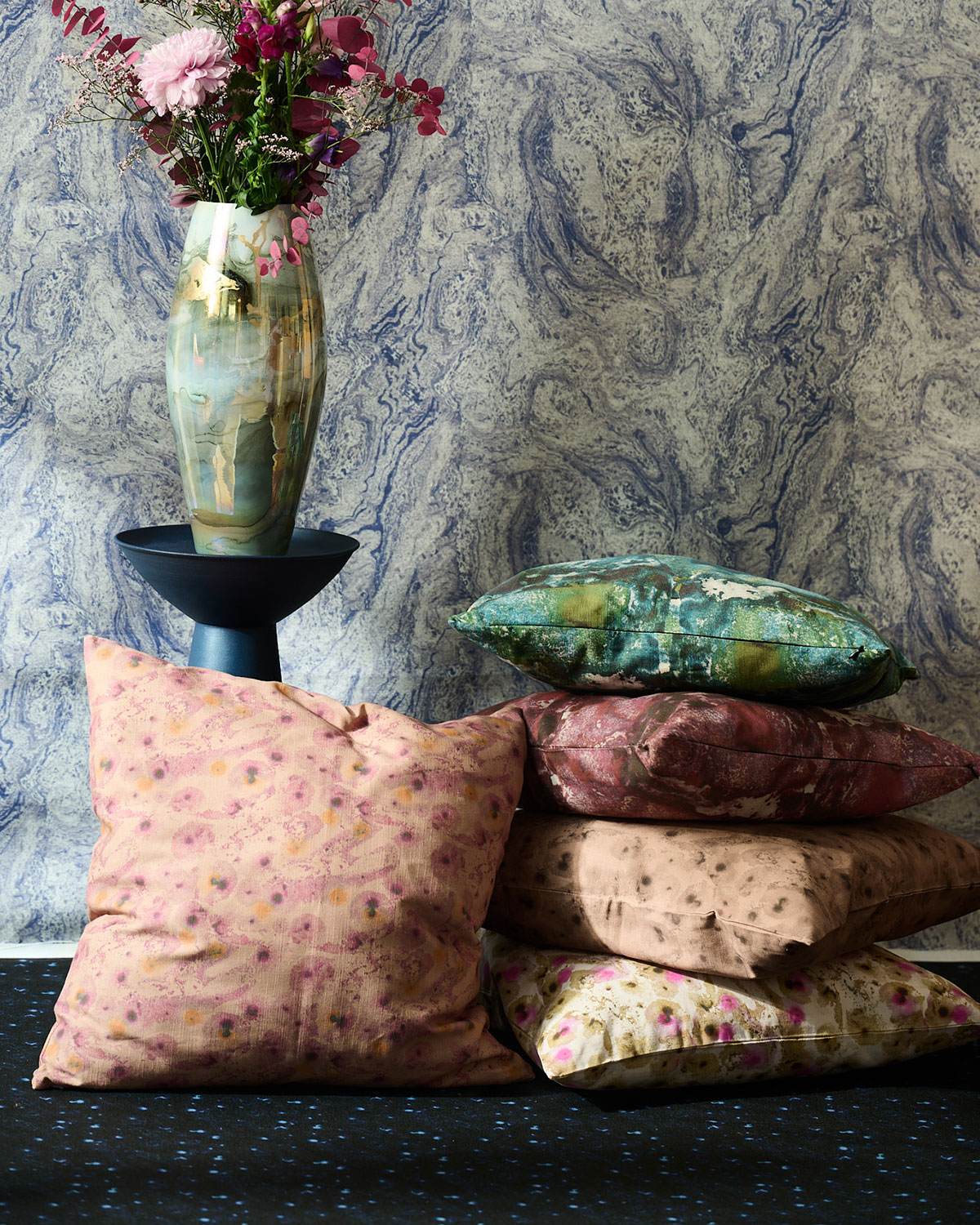 Selene Cushion collection stucked in a room with a vase and flowers