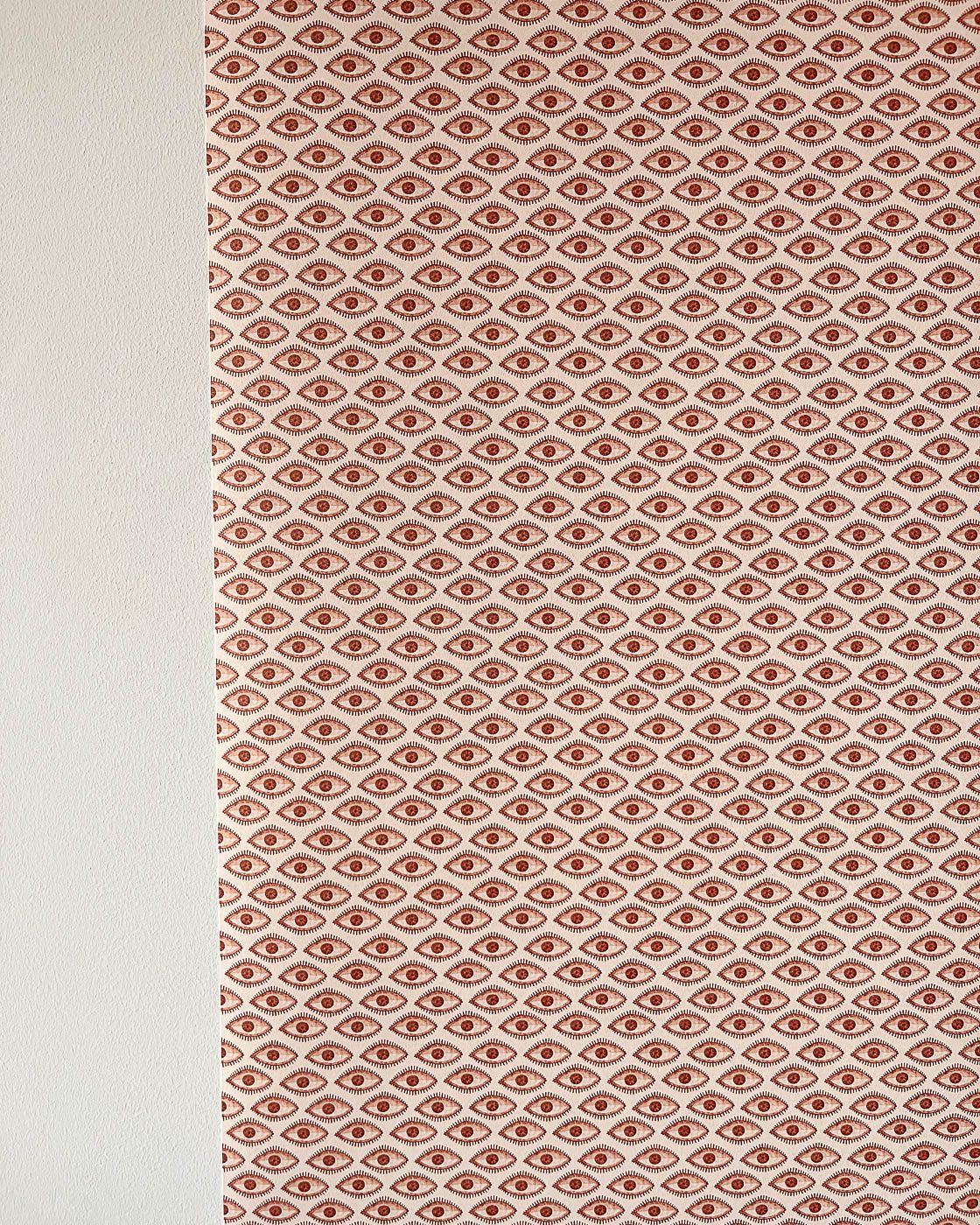 Brown evil eye wallpaper on wall in brown